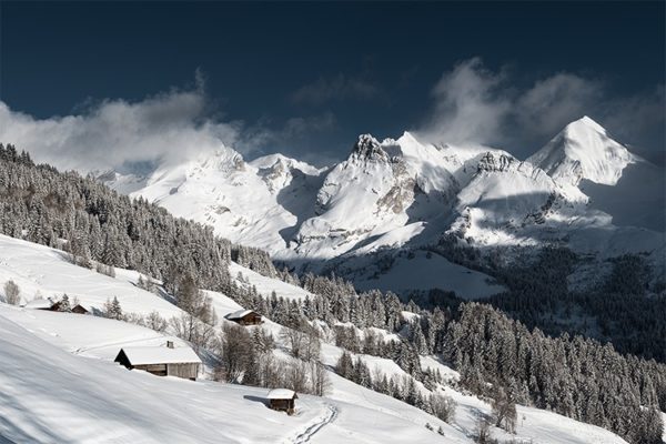 Vue depuis le Grand Bornand sur les combes des Aravis enneigées, France. Format paysage.